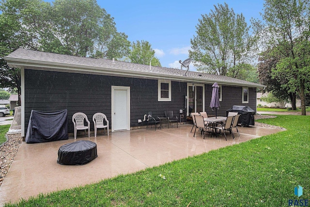 1034 N Elmwood Ave, Luverne, MN 56156 - rear view of property with a yard, a patio area, and an outdoor fire pit