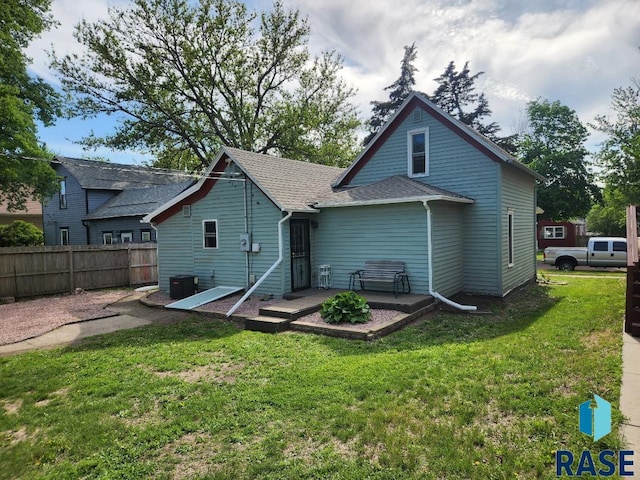 912 N Spring Ave, Sioux Falls, SD 57104 - back of house with a shingled roof and central AC