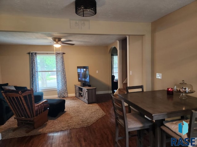 912 N Spring Ave, Sioux Falls, SD 57104 - dining room with arched walkways, wood finished floors, stairs, baseboards, and a ceiling fan