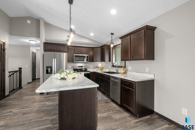 525 Quartzite Ave, Tea, SD 57064 - kitchen with stainless steel appliances, a sink, dark brown cabinets, a center island, and wood finished floors