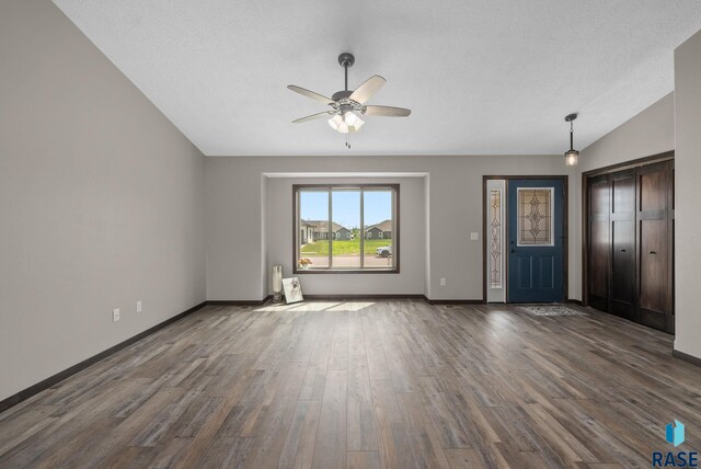 525 Quartzite Ave, Tea, SD 57064 - unfurnished living room featuring a ceiling fan, dark wood-style flooring, baseboards, and vaulted ceiling