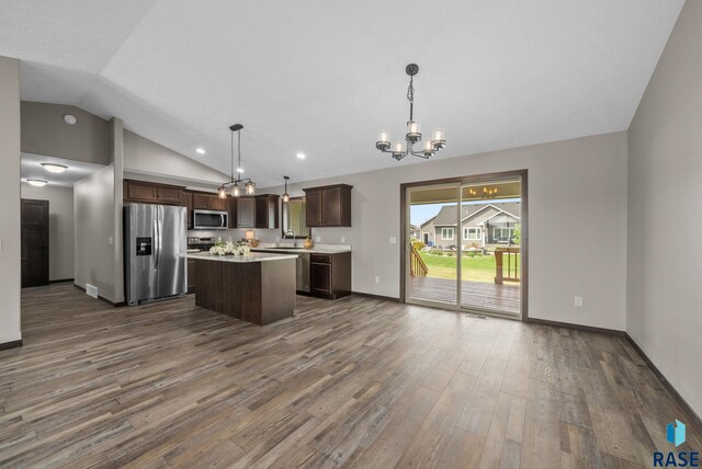 525 Quartzite Ave, Tea, SD 57064 - kitchen with stainless steel appliances, a chandelier, vaulted ceiling, dark brown cabinetry, and dark wood finished floors