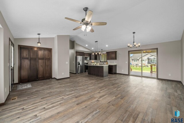 525 Quartzite Ave, Tea, SD 57064 - unfurnished living room with vaulted ceiling, wood finished floors, a chandelier, ceiling fan, and baseboards