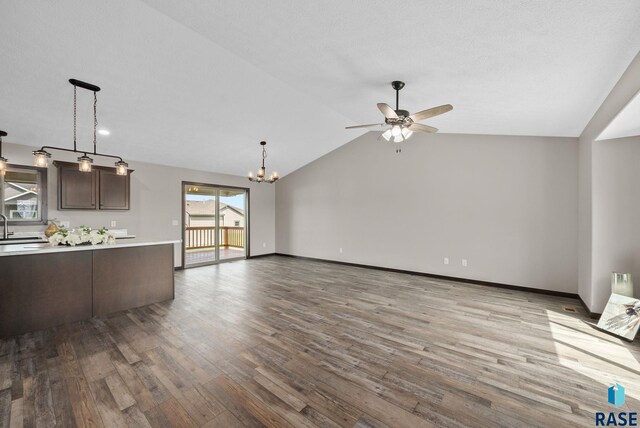 525 Quartzite Ave, Tea, SD 57064 - unfurnished living room featuring a ceiling fan, a sink, wood finished floors, a chandelier, and lofted ceiling
