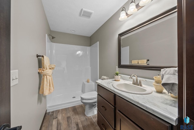 525 Quartzite Ave, Tea, SD 57064 - full bathroom with wood finished floors, a shower, toilet, and vanity