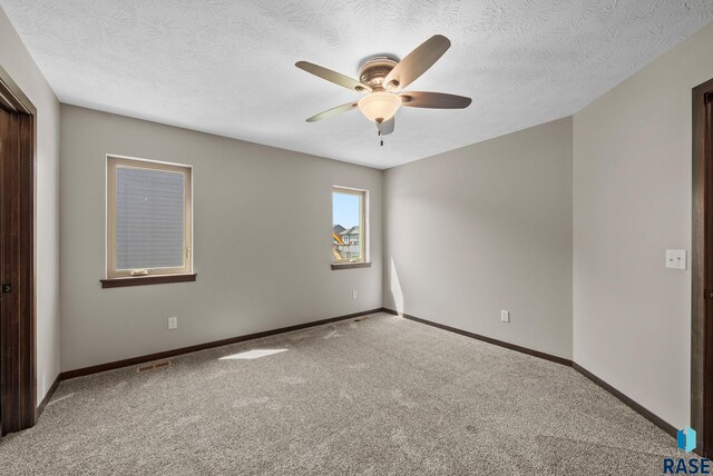 525 Quartzite Ave, Tea, SD 57064 - unfurnished bedroom featuring carpet floors, baseboards, a textured ceiling, and a ceiling fan