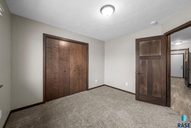 525 Quartzite Ave, Tea, SD 57064 - unfurnished bedroom featuring a closet, carpet flooring, baseboards, and a textured ceiling