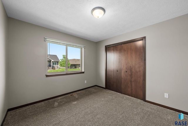 525 Quartzite Ave, Tea, SD 57064 - unfurnished bedroom featuring a closet, carpet flooring, baseboards, and a textured ceiling