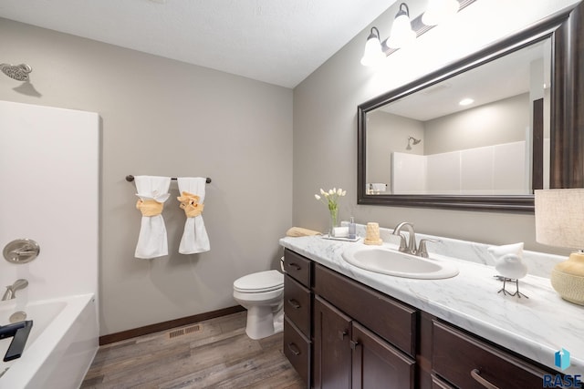525 Quartzite Ave, Tea, SD 57064 - full bath featuring wood finished floors, toilet, baseboards, vanity, and bathing tub / shower combination