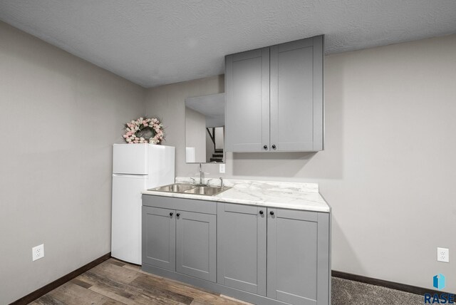 525 Quartzite Ave, Tea, SD 57064 - kitchen with gray cabinetry, freestanding refrigerator, a sink, light countertops, and a textured ceiling