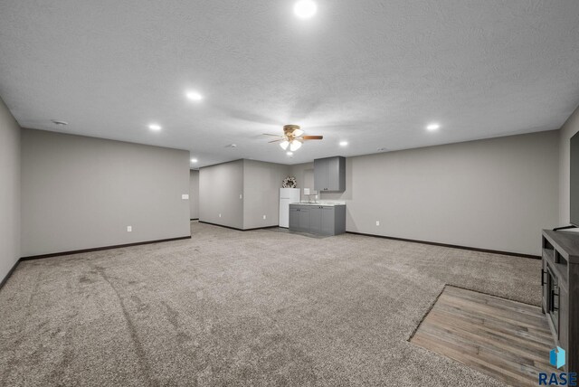 525 Quartzite Ave, Tea, SD 57064 - unfurnished living room featuring recessed lighting, light colored carpet, ceiling fan, baseboards, and a textured ceiling