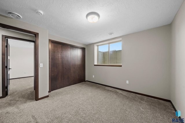 525 Quartzite Ave, Tea, SD 57064 - unfurnished bedroom with carpet, baseboards, a closet, and a textured ceiling