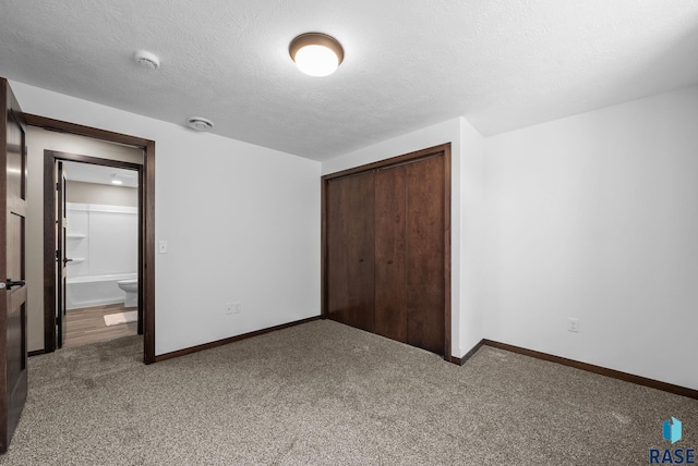 525 Quartzite Ave, Tea, SD 57064 - unfurnished bedroom featuring a closet, carpet floors, baseboards, and a textured ceiling