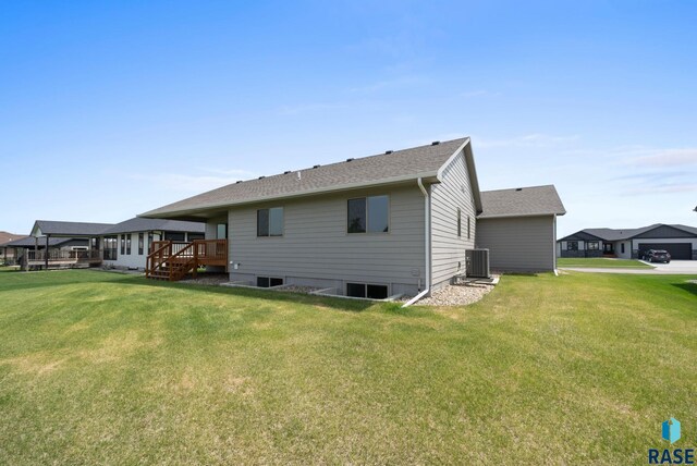 525 Quartzite Ave, Tea, SD 57064 - back of house featuring a yard, central AC, a wooden deck, and roof with shingles