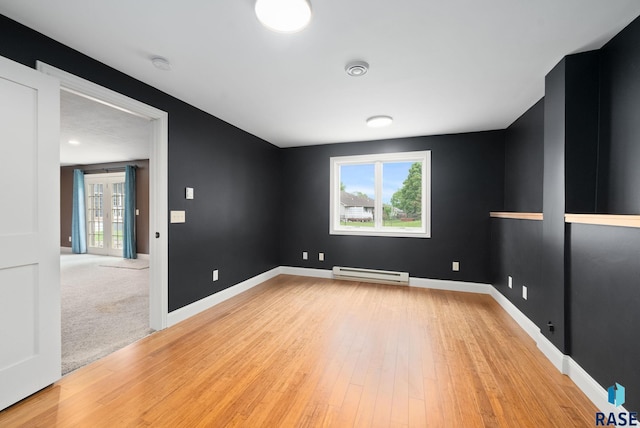 5516 S Tierney Pl, Sioux Falls, SD 57108 - empty room with baseboard heating, plenty of natural light, light wood-type flooring, and a smoke detector