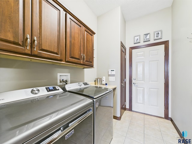 8113 S Copper Ridge Rd, Sioux Falls, SD 57108 - laundry area with separate washer and dryer, cabinet space, light tile patterned floors, and baseboards