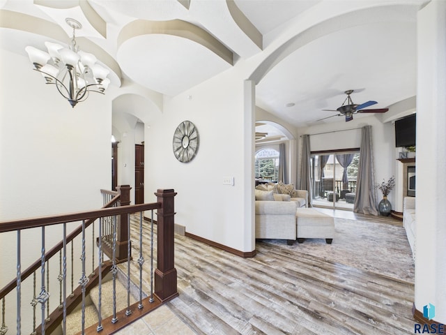 8113 S Copper Ridge Rd, Sioux Falls, SD 57108 - corridor featuring arched walkways, wood finished floors, baseboards, and a chandelier