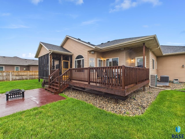 8113 S Copper Ridge Rd, Sioux Falls, SD 57108 - rear view of house featuring a fire pit, a sunroom, a patio area, central air condition unit, and a deck
