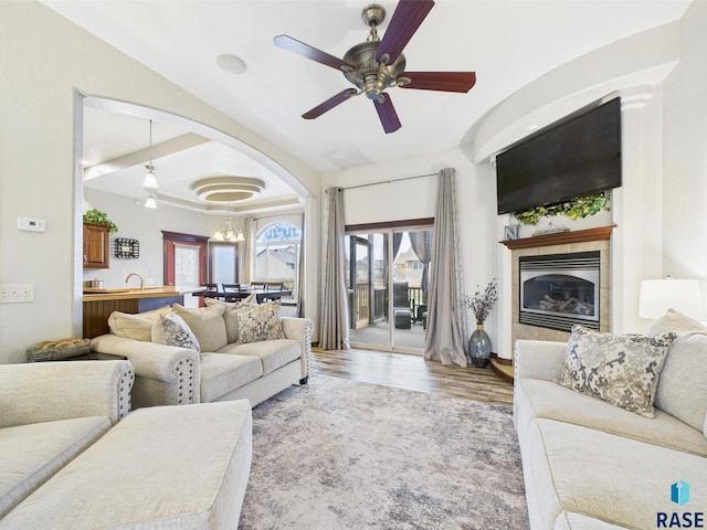 8113 S Copper Ridge Rd, Sioux Falls, SD 57108 - living room featuring a fireplace, a chandelier, ceiling fan, and wood finished floors