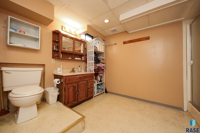 109 N Frank Ave, Garretson, SD 57030 - full bath with a paneled ceiling, tile patterned floors, toilet, vanity, and a shower with door