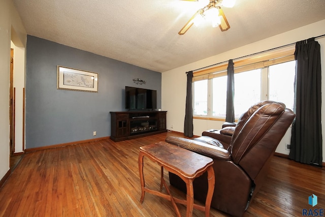109 N Frank Ave, Garretson, SD 57030 - living room featuring a ceiling fan, hardwood / wood-style flooring, baseboards, and a textured ceiling