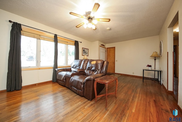 109 N Frank Ave, Garretson, SD 57030 - living room featuring wood-type flooring, ceiling fan, baseboards, and a textured ceiling