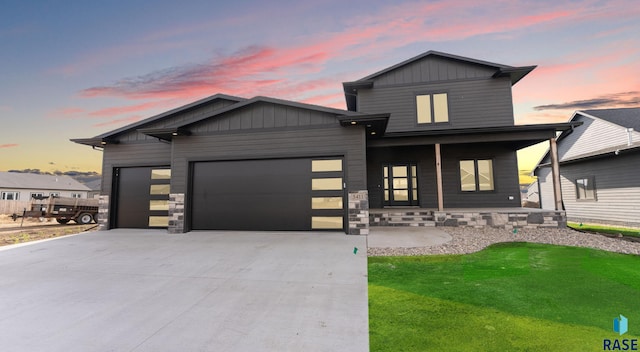 5411 W Patriot St, Sioux Falls, SD 57107 - modern home with a garage, a porch, concrete driveway, and stone siding