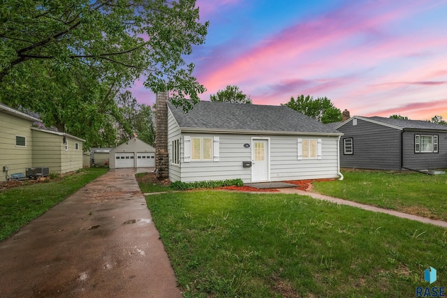 331 E Norton Ave, Salem, SD 57058 - bungalow-style house featuring a detached garage, an outdoor structure, a lawn, a chimney, and central AC unit