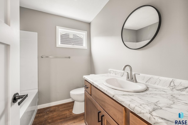 331 E Norton Ave, Salem, SD 57058 - full bath featuring wood finished floors, toilet, vanity, baseboards, and a tub