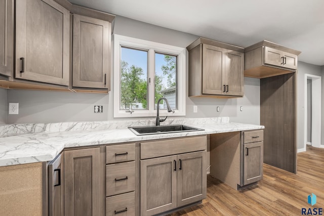 331 E Norton Ave, Salem, SD 57058 - kitchen with a sink, light wood-style flooring, and light countertops