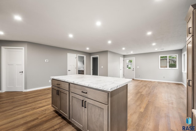 331 E Norton Ave, Salem, SD 57058 - kitchen featuring recessed lighting, baseboards, light wood finished floors, a kitchen island, and open floor plan