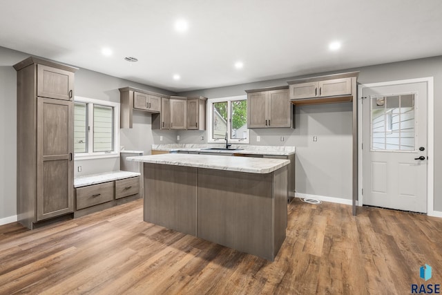 331 E Norton Ave, Salem, SD 57058 - kitchen with a sink, a center island, wood finished floors, baseboards, and recessed lighting