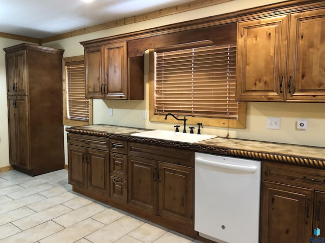 231 S 5th St, Menno, SD 57045 - kitchen featuring white dishwasher, dark countertops, a sink, light tile patterned floors, and dark brown cabinetry