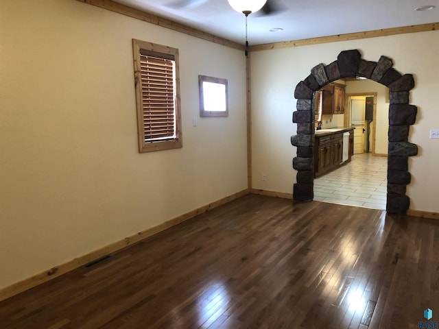 231 S 5th St, Menno, SD 57045 - spare room with light wood-style flooring, baseboards, and arched walkways