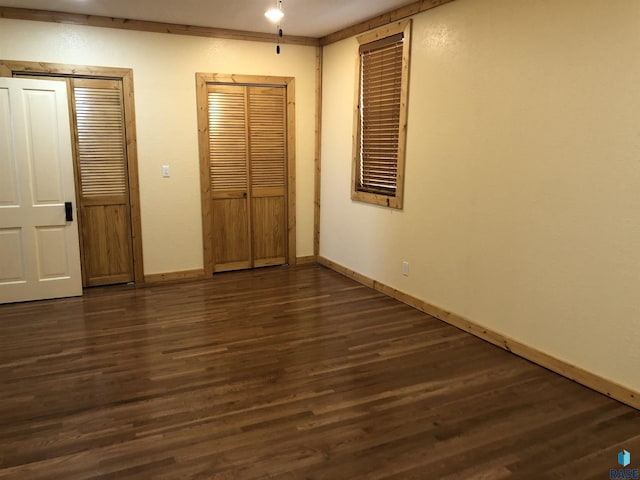 231 S 5th St, Menno, SD 57045 - unfurnished bedroom featuring baseboards and dark wood finished floors