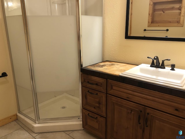 231 S 5th St, Menno, SD 57045 - full bath with a shower stall, tile patterned floors, and vanity