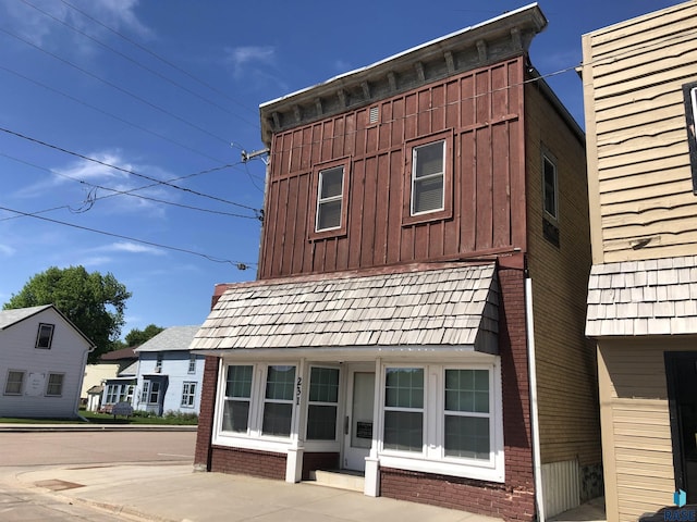 231 S 5th St, Menno, SD 57045 - view of home's exterior featuring board and batten siding and brick siding