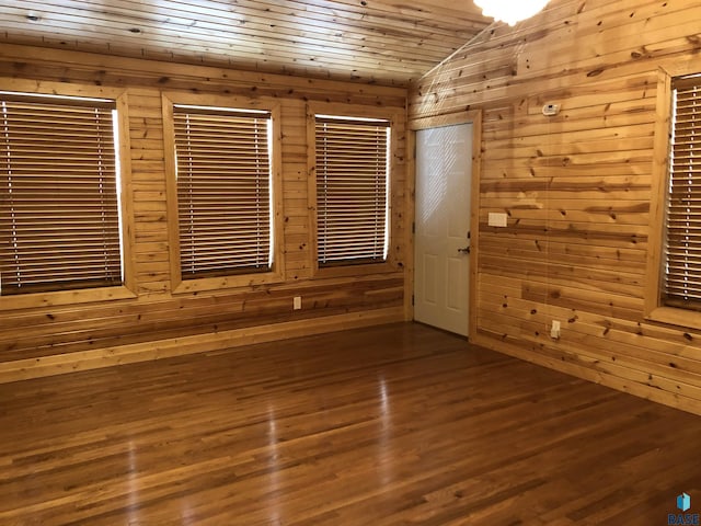 231 S 5th St, Menno, SD 57045 - empty room featuring wood walls, vaulted ceiling, dark wood-style flooring, and wooden ceiling
