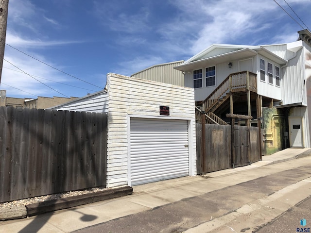 231 S 5th St, Menno, SD 57045 - view of front facade featuring stairway and board and batten siding