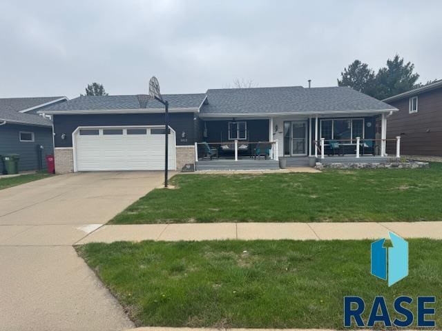 5813 W Clay St, Sioux Falls, SD 57106 - ranch-style home featuring a garage, a front lawn, driveway, covered porch, and brick siding