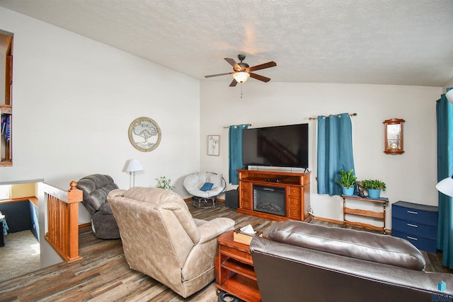 5813 W Clay St, Sioux Falls, SD 57106 - living area with vaulted ceiling, wood finished floors, a ceiling fan, a textured ceiling, and a glass covered fireplace