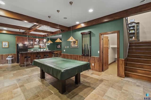2502 S Big Timber Pl, Sioux Falls, SD 57105 - playroom featuring light stone finish flooring, wet bar, a wainscoted wall, beam ceiling, and wood walls