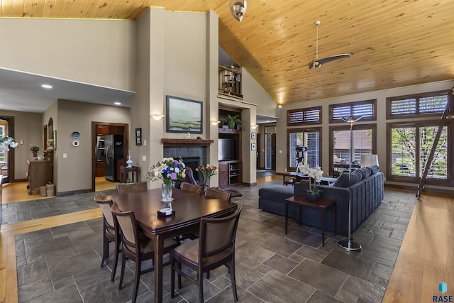 2502 S Big Timber Pl, Sioux Falls, SD 57105 - dining room featuring high vaulted ceiling, a tile fireplace, baseboards, wood ceiling, and recessed lighting