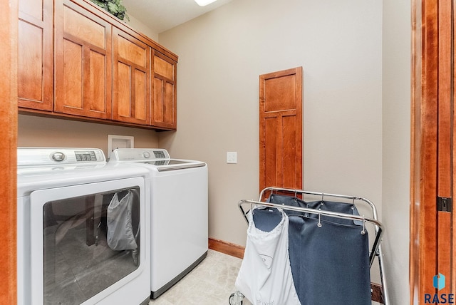 2502 S Big Timber Pl, Sioux Falls, SD 57105 - laundry area featuring separate washer and dryer, cabinet space, baseboards, and light tile patterned floors