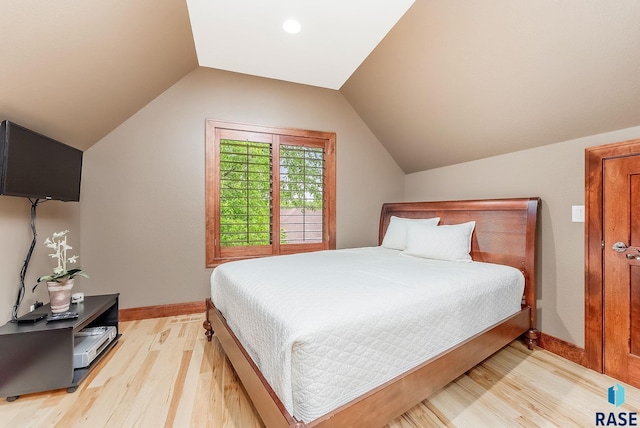 2502 S Big Timber Pl, Sioux Falls, SD 57105 - bedroom with light wood-style flooring, lofted ceiling, and baseboards