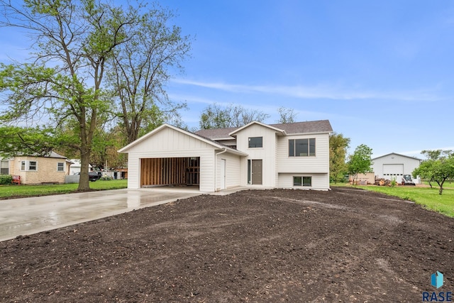 851 N 4th Ave, Canistota, SD 57012 - view of front of home with driveway, board and batten siding, an attached garage, and roof with shingles