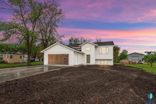 851 N 4th Ave, Canistota, SD 57012 - view of front facade with driveway, board and batten siding, and a garage