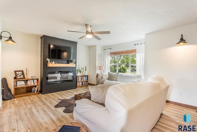 1808 S Mulberry Ave Unit D, Brandon, SD 57005 - living room with ceiling fan, wood finished floors, baseboards, and a fireplace