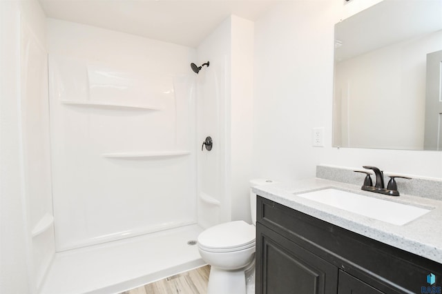 4301 E 28th St, Sioux Falls, SD 57103 - bathroom with a shower, toilet, vanity, and wood finished floors