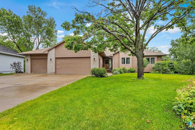 6700 W Snowberry Cir, Sioux Falls, SD 57106 - view of front of house with a garage, brick siding, a front lawn, and driveway